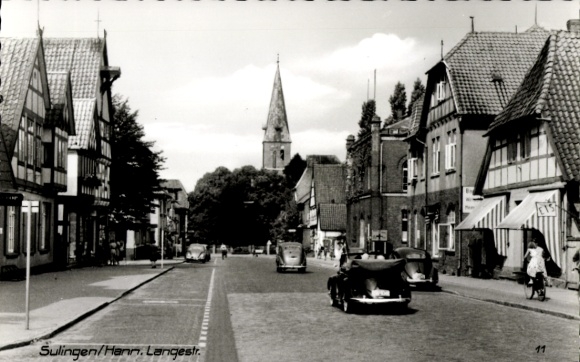 Postcard Sulingen in Lower Saxony, street with old buildings, church in the background, cars, people