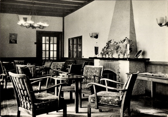Postcard Ostseebad Bansin on Usedom, cozy interior, wooden chairs, fireplace, decorated with plants...