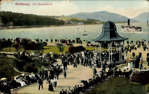 Postcard Rothesay Scotland, bandstand, crowds, large water, hills in the background