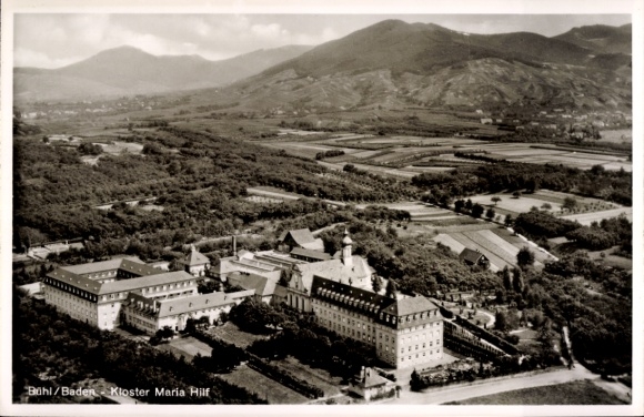 Postcard Sand Bühl in Baden Black Forest, aerial view of Maria Hilf Monastery, mountains in the background