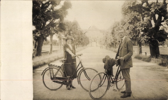 Photo Postcard Woman and man with bicycles on an avenue