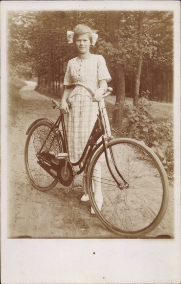 Photo of young woman with bicycle, portrait