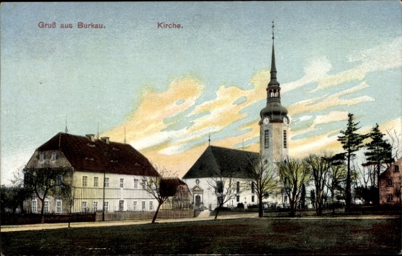 PC Burkau in Saxony, front shows church, houses, trees, evening sky