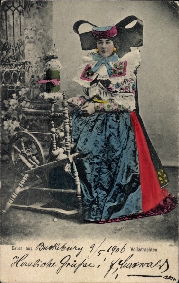 Postcard Bückeburg in the district of Schaumburg, woman in traditional costume spinning