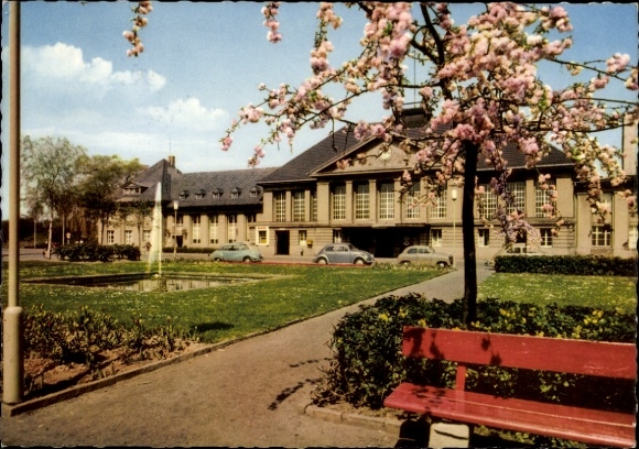 Viersen in North Rhine-Westphalia, building with garden, cherry blossoms, cars, park bench, blue...