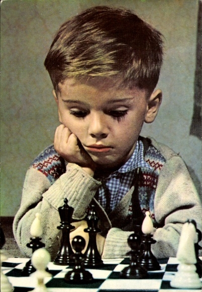 Postcard Little boy sits concentrated at the chessboard, chess