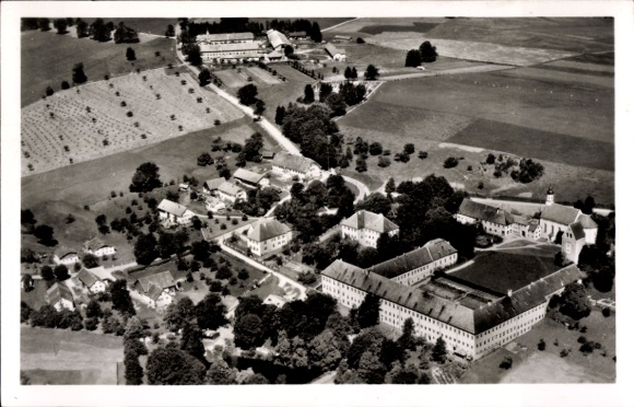 Postcard Wessobrunn in Upper Bavaria, aerial view of a monastery, green meadows, agricultural areas