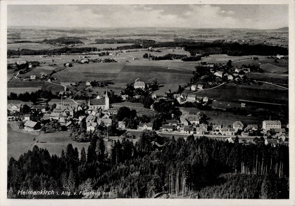 Ak Heimenkirch im Allgäu, Luftaufnahme, Kirche, ländliche Umgebung, Berge, Bäume