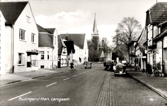 Postcard Sulingen in Lower Saxony, beautiful street with historic buildings, church in the background, ...