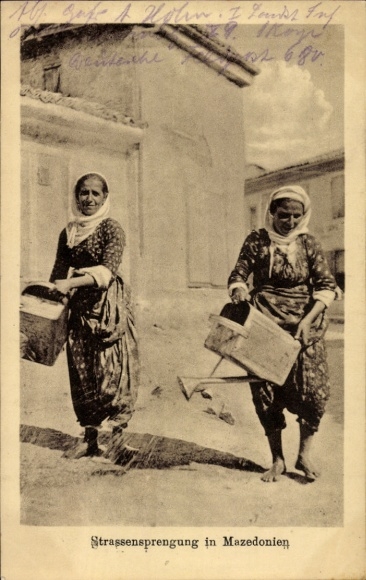 Postcard Macedonia, road blasting, women watering the road with watering cans