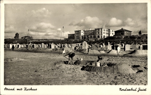 Postcard North Sea resort of Juist in East Frisia, beach with spa house, sand castles