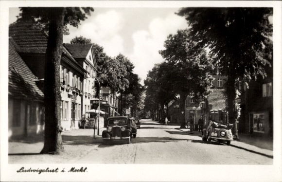 PC Ludwigslust in Mecklenburg, street scene with cars and hotel