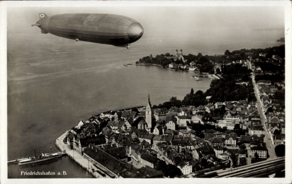 Postcard Friedrichshafen on Lake Constance, airship LZ 127 Graf Zeppelin in full flight, aerial photograph