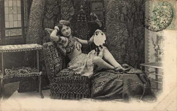 Postcard Paris I Louvre, A young woman in oriental clothing lies on a divan.