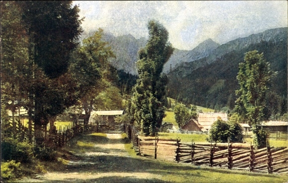 Postcard Bodental in Carinthia, landscape with trees, path, fences, mountains in the background