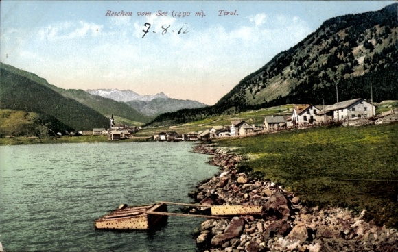 Postcard Reschen am See Resia South Tyrol, view of the town from the lake shore
