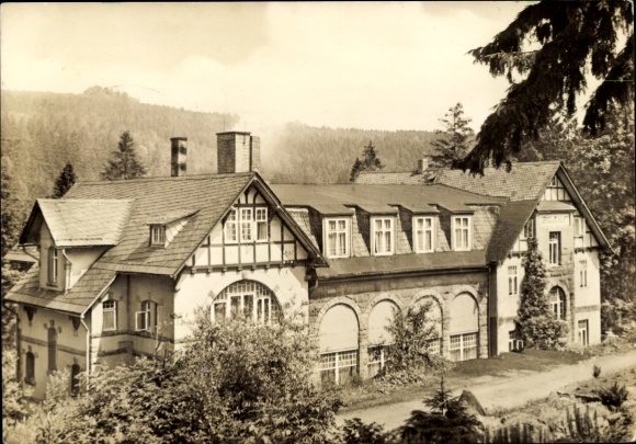 Postcard Schierke Wernigerode in the Harz Mountains, front view of a historic building, forest landscape in the...