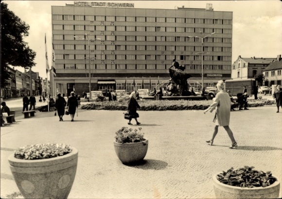 Ak Schwerin in Mecklenburg, Hotel Stadt  moderne Architektur, Stadtplatz, Menschen, Blumenbeet