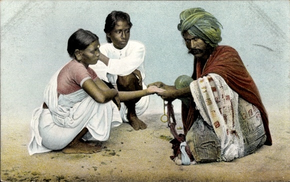 Postcard Indian fortune teller practicing his craft, palm reader