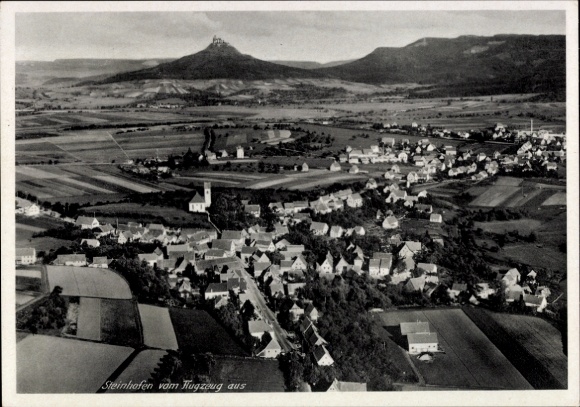 Ak Steinhofen Bisingen im Zollernalbkreis, Luftaufnahme von  ländliche Umgebung, Kirche, Berge im