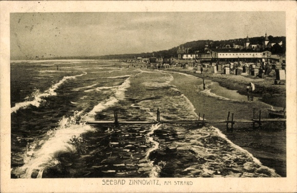 Picture Baltic Sea resort Zinnowitz on Usedom, seaside resort beach view, waves, buildings in the background