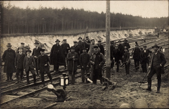 Photo Postcard Men on railway tracks, railway construction