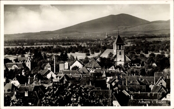 Postcard Achern in Baden Black Forest, city view with roofs, church, mountain in the background, landscape