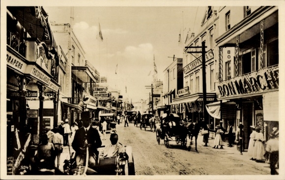 Postcard Barbados BWI, street scene, buildings, horse-drawn carriages, passersby