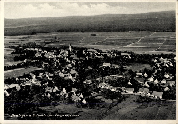 Postcard Dettingen an der Erms, aerial view of Dettingen, rural landscape, church visible, much