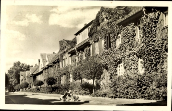 Hennigsdorf an der Oberhavel, residential buildings, overgrown facade, street, trees, two children on...