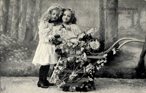 Happy birthday card, two girls, handcart decorated with flowers