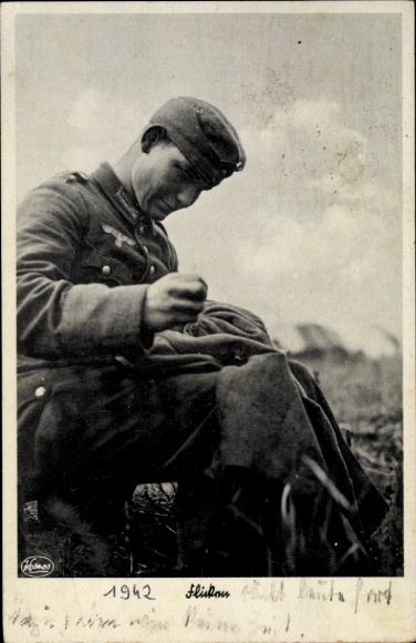 Wehrmacht soldier mending his uniform