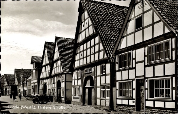 Postcard Lügde in the Weserbergland, Hintere Straße, half-timbered houses, car, bicycle