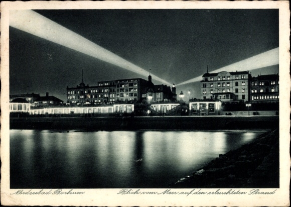 Postcard North Sea resort Borkum in East Frisia, night shot, illuminated beach, buildings, sea