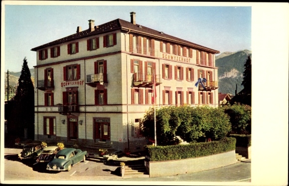 KP Seewen Canton Schwyz, Hotel Schwyzerhof, dwa samochody, w tle górski krajobraz
