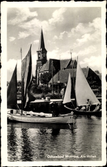 Postcard Ostseebad Wustrow Fischland, harbor with boats, church in the background, clouds over water