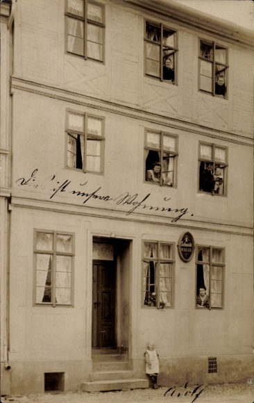 Photo Postcard Burg near Magdeburg, residential building, residents at the windows, Wilh. Müller