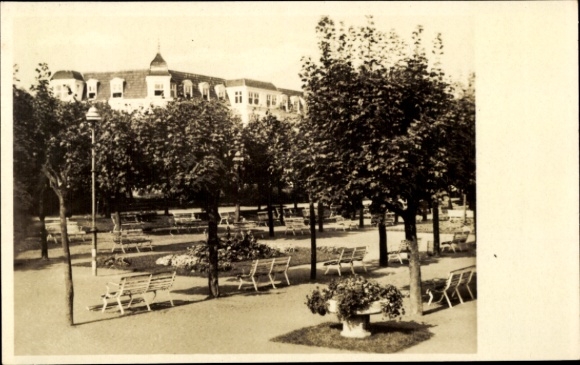 Postcard Ostseebad Ahlbeck on Usedom, park with benches and trees, view of buildings in the background