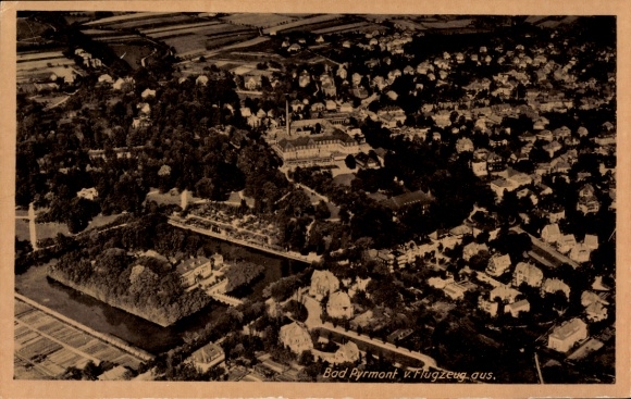Postcard Bad Pyrmont in Lower Saxony, aerial view of cityscape, houses and nature