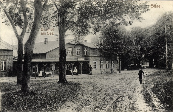 Postcard Süsel in Ostholstein, Gasthof am See, street section in town