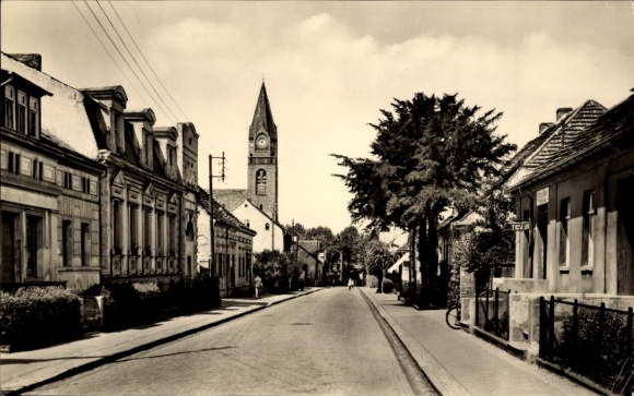 Postcard Ketzin on the Havel, street with houses, church in the background, sunny sky