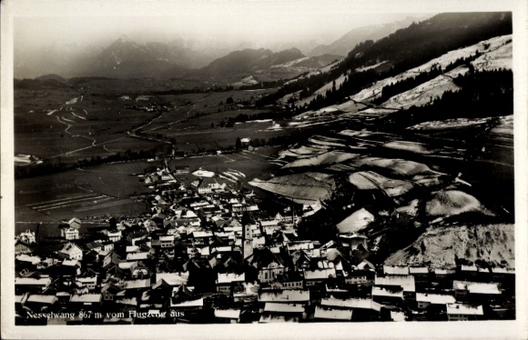 Postcard Nesselwang in Allgäu, aerial view of mountains in the background, winter landscape