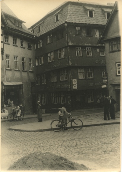 Photo of Treuenbrietzen in Brandenburg, street scene, shops, inn, passersby, bicycle, March 2, 1941
