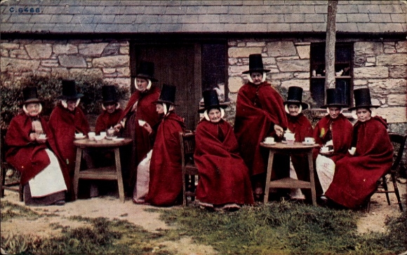Postcard Wales, women in traditional costumes, tables, house, tea