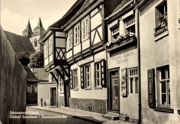 Postcard Schönebeck on the Elbe, half-timbered houses, Rosmarienstraße, church buildings in the background