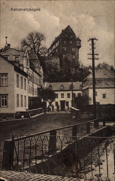 Picture of Katzenelnbogen in the Taunus Mountains, view of a village with houses, a river, and an old building...