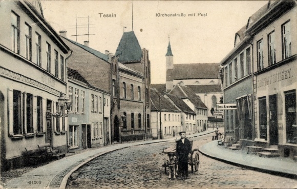 Postcard Tessin in Mecklenburg, Kirchenstraße, post office, shops, boy with dog cart