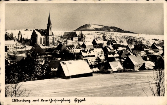 Geising Altenberg in the Ore Mountains, snow-covered townscape, church, Geisingberg in the background...