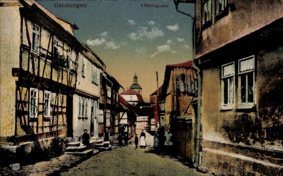 Postcard Gerstungen in Thuringia, alley with half-timbered houses, sky with clouds, two children and a woman