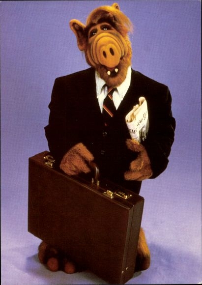 Postcard Alf in suit, briefcase, newspaper